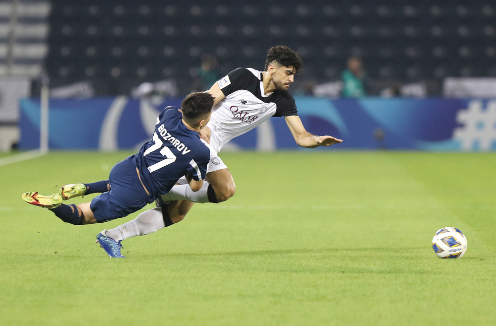 Al Sadd's Iranian defender Amin Hazbavi (right) and Nasaf's Oybek Bozorov vie for the ball possession during yesterday's match at Jassim Bin Hamad Stadium. PICTURES: Mohammed Farag 