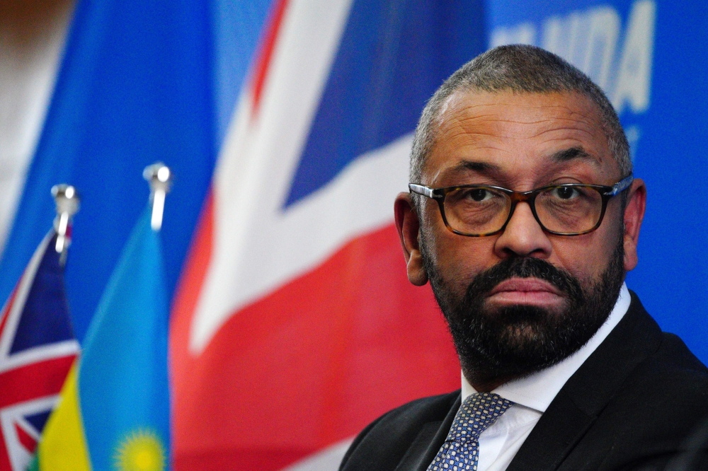 Britain's Home Secretary James Cleverly speaks during a joint press conference with his Rwanda's Foreign Minister after signing a new treaty, in Kigali on December 5, 2023. (Photo by Ben Birchall / POOL / AFP)