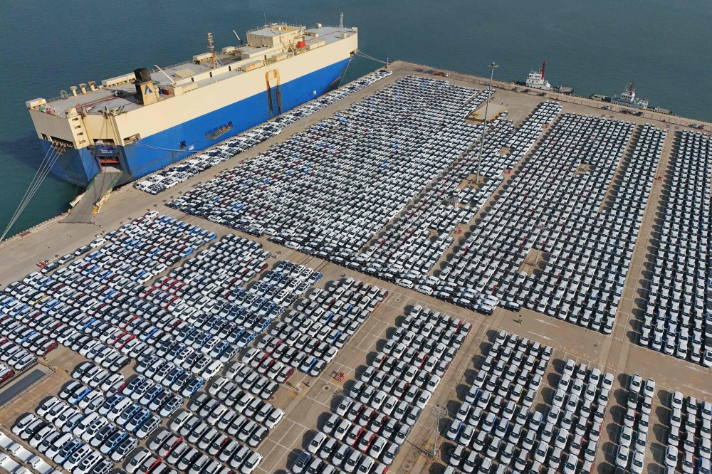 Cars wait to be loaded onto a ship for export at the port in Yantai, in China's eastern Shandong province on December 7, 2023. Photo by AFP
