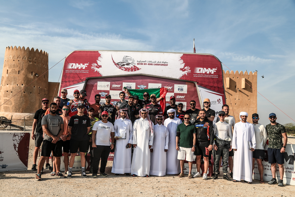 Participants and officials pose for a group photo after the final round of Qatar Off Road Championship. 
