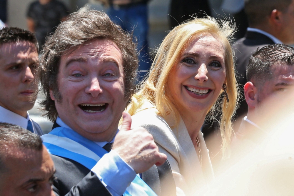 Argentina's new president Javier Milei (L) and his sister Karina Milei head to Casa Rosada Presidential Palace in an open car after he was sworn in during an inauguration ceremony at the Congress in Buenos Aires on December 10, 2023. (Photo by Cezaro DE LUCA / AFP)
