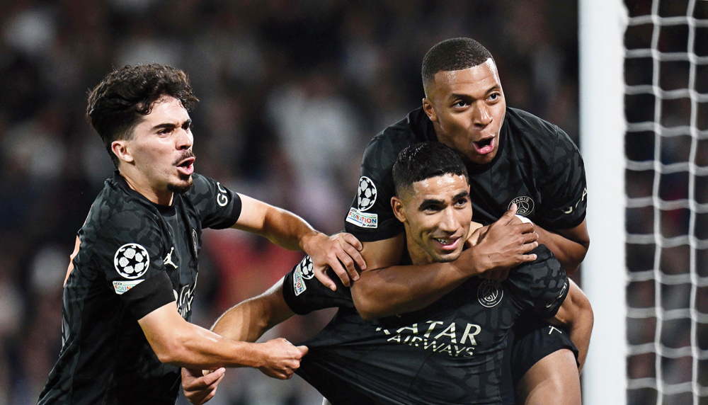 PSG’s Achraf Hakimi (centre) celebrates with teammates Kylian Mbappe (right) and Vitinha after scoring a goal against Borussia Dortmund in Paris. AFP