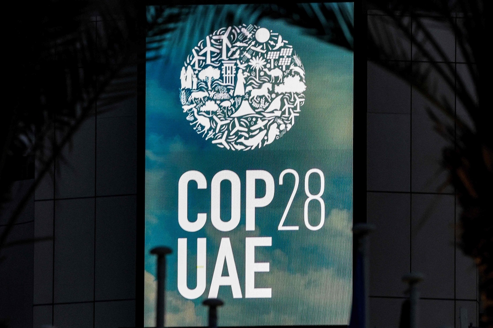 The logo of the United Nations Climate Change Conference COP28 is pictured at Expo City in Dubai on December 12, 2023. Photo by Giuseppe CACACE / AFP