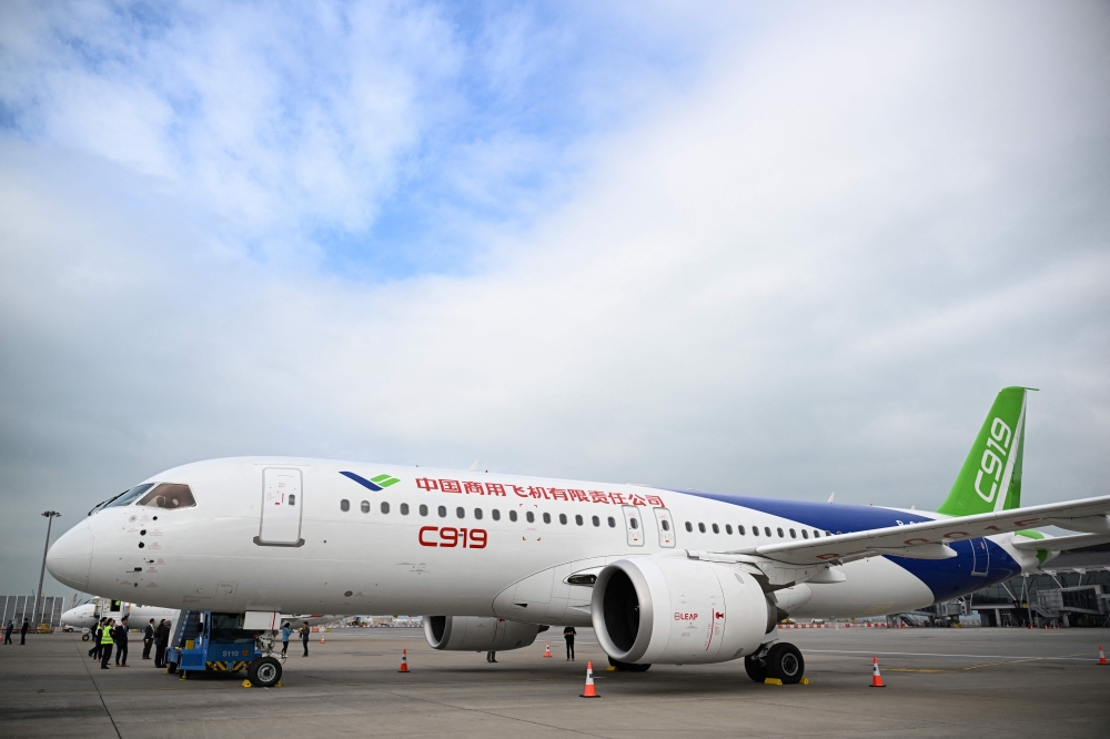 China's domestically produced C919 passenger jet is seen on display at Hong Kong International Airport on December 13, 2023. (Photo by Peter Parks / AFP)
