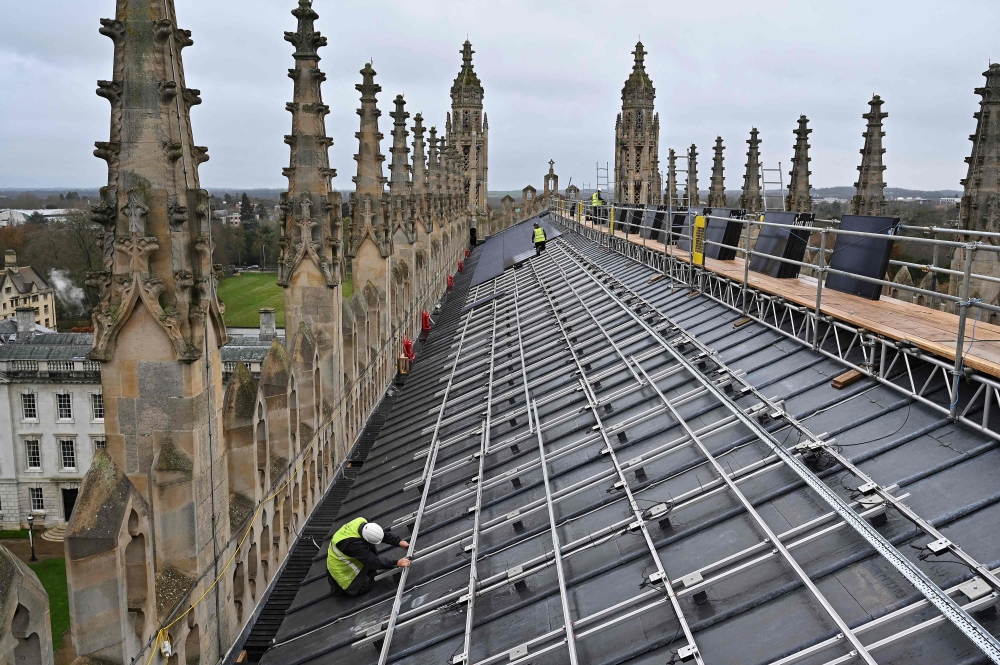 Solar panels are installed on the roof of King's College Chapel in Cambridge, eastern England on December 13, 2023. (Photo by Justin Tallis / AFP)
