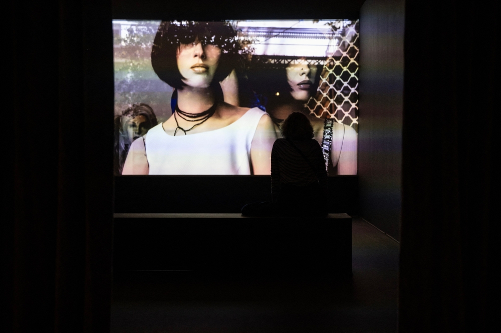 A visitor watches the video of a performance screened in the exhibition titled 'What if women ruled the world?' at the National Museum of Contemporary Art (EMST) in Athens on December 14, 2023. (Photo by Angelos Tzortzinis / AFP) 
