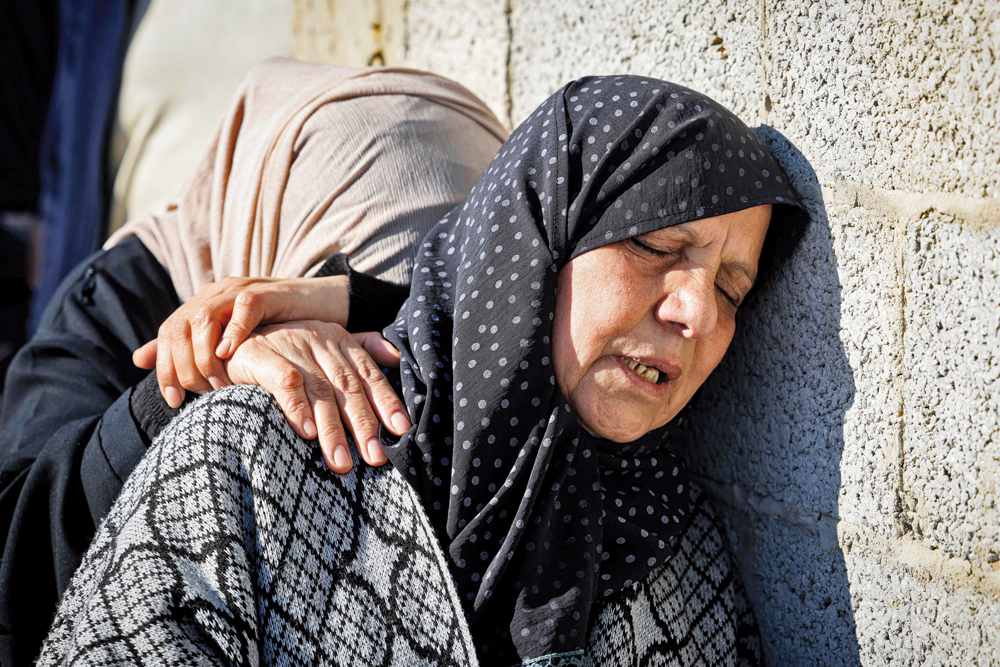 Relatives mourn during the funeral of Al Jazeera cameraman Samer Abu Daqqa, who was killed during Israeli bombardment, in Khan Yunis, Gaza Strip, yesterday.