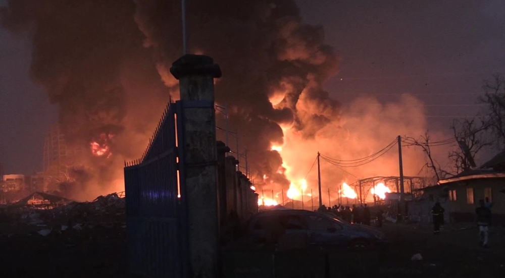 This image grab taken from AFPTV video footage on December 18, 2023 shows flames from the fire at Conakry's main fuel depot. Photo by STRINGER / AFP