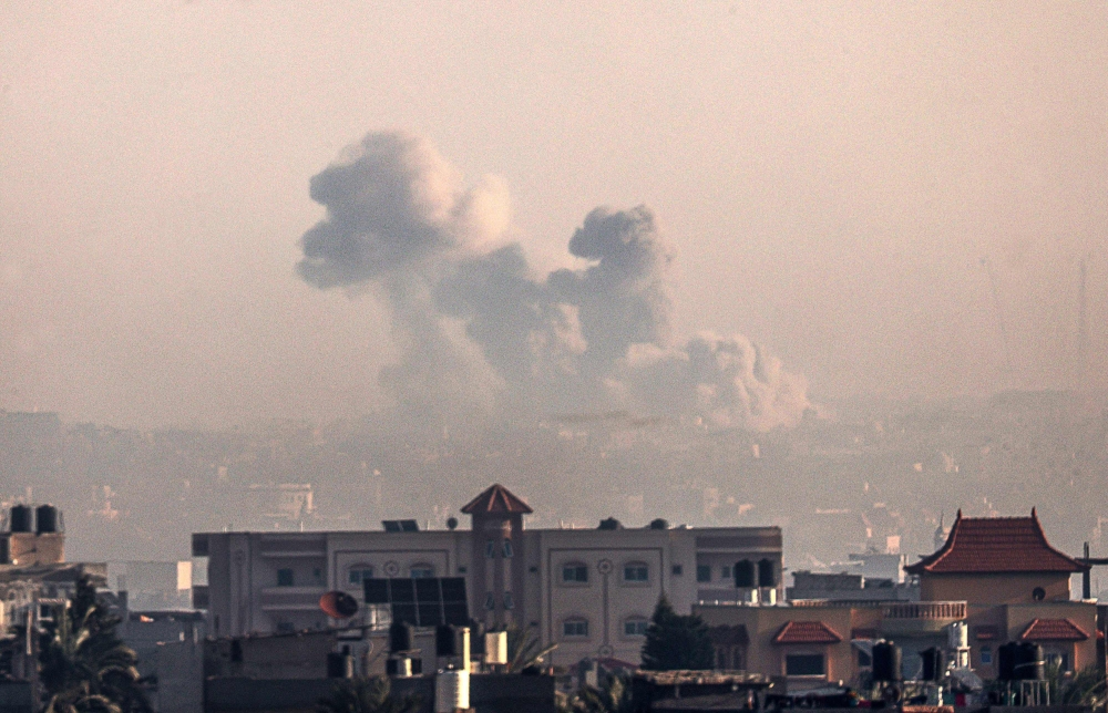 A picture taken from Rafah shows smoke billowing over Khan Yunis in the southern Gaza Strip on December 19, 2023. (Photo by Said Khatib / AFP)