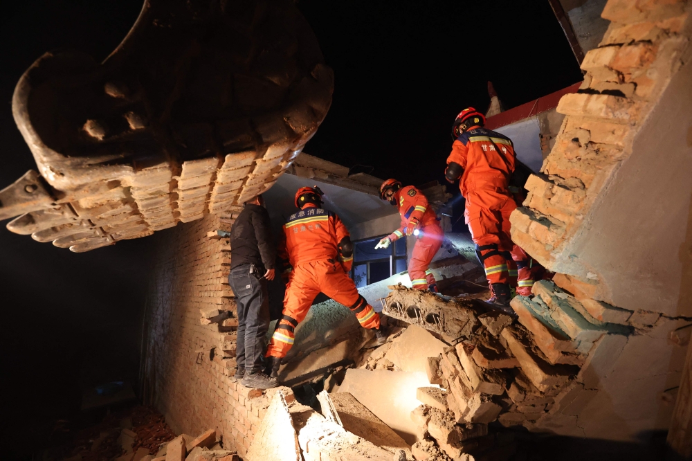 Rescue workers search a house for survivors after an earthquake in Kangdiao village, Dahejia, Jishishan County, in northwest China's Gansu province on December 19, 2023. Photo by AFP