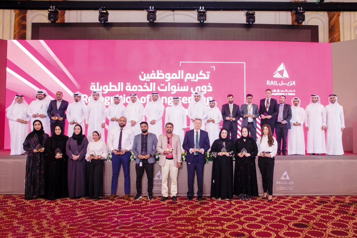 Qatar Rail Managing Director and CEO H E Dr. Abdullah bin Abdulaziz bin Turki Al Subaie with officials and employees with long service during a ceremony. 