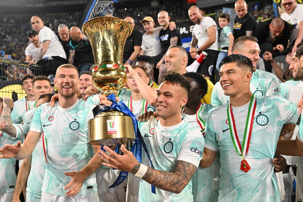 File: Inter Milan's Argentinian forward Lautaro Martinez (C) celebrates with the trophy after winning the Italian Cup (Coppa Italia) final football match between Fiorentina and Inter Milan at the Stadio Olimpico in Rome, on May 24, 2023. (Photo by Alberto Pizzoli / AFP)