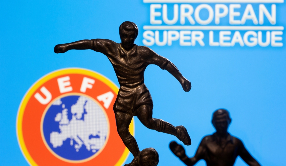 FILE PHOTO: Metal figures of football players are seen in front of the words 