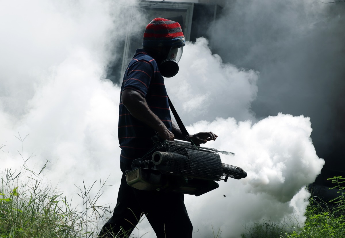 A worker sprays insecticide to prevent mosquito breeding at a railway station in Colombo, Sri Lanka, May 13, 2023. Photo by Ajith Perera/Xinhua