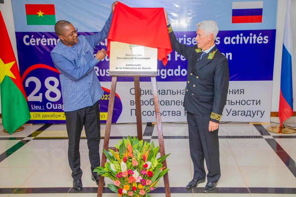 Russia's ambassador to Ivory Coast, Alexey Saltykov (right) and Burkina Faso's Minister of Foreign Affairs, Karamoko Jean-Marie Traore, unveil a plaque during a ceremony to mark the re-opening of the Russian Embassy in Burkina Faso, in Ouagadougou, on December 28, 2023. (Photo by Kiemtore Lassane Bruno / AFP)