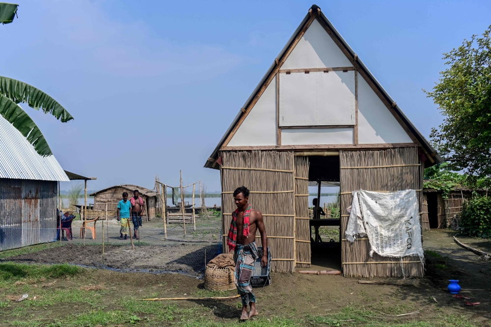 In this photograph taken on September 3, 2023, a man walks out from a mobile modular shelter 