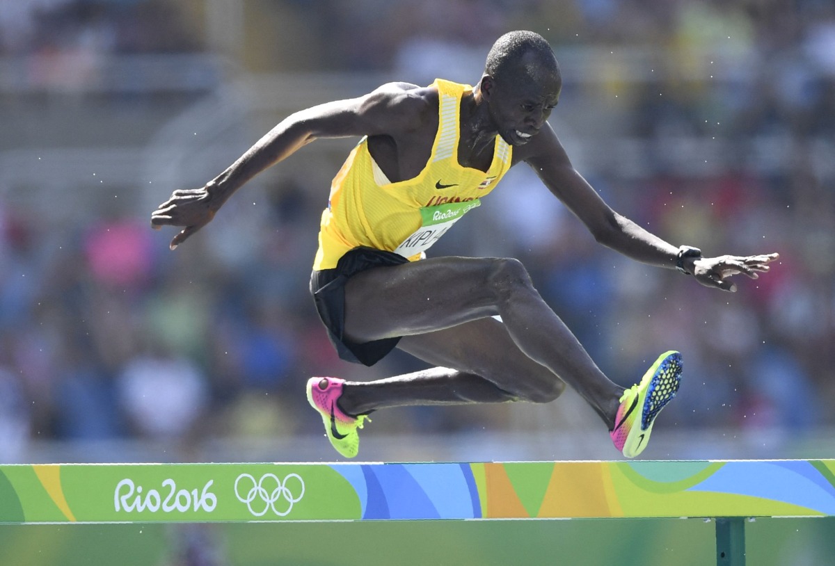 (FILES) Uganda's Benjamin Kiplagat competes in the Men's 3000m Steeplechase Round 1 during the athletics event at the Rio 2016 Olympic Games at the Olympic Stadium in Rio de Janeiro on August 15, 2016.  (Photo by Fabrice COFFRINI / AFP)