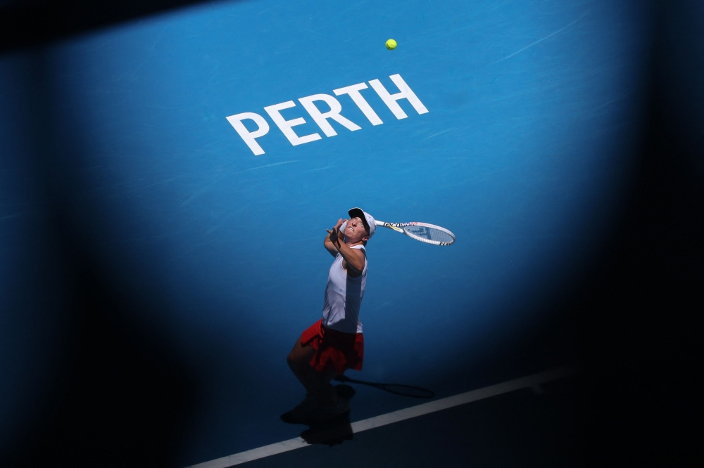 Poland's Iga Swiatek serves against China's Qinwen Zheng during their women's singles match at the United Cup tennis tournament in Perth on January 3, 2024. Photo by COLIN MURTY / AFP