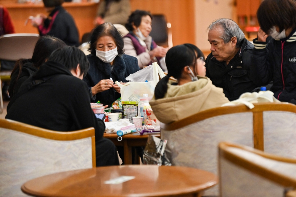 Evacuees rest at a shelter in Nanao, Ishikawa prefecture on January 3, 2024. (Photo by Kazuhiro Nogi / AFP)