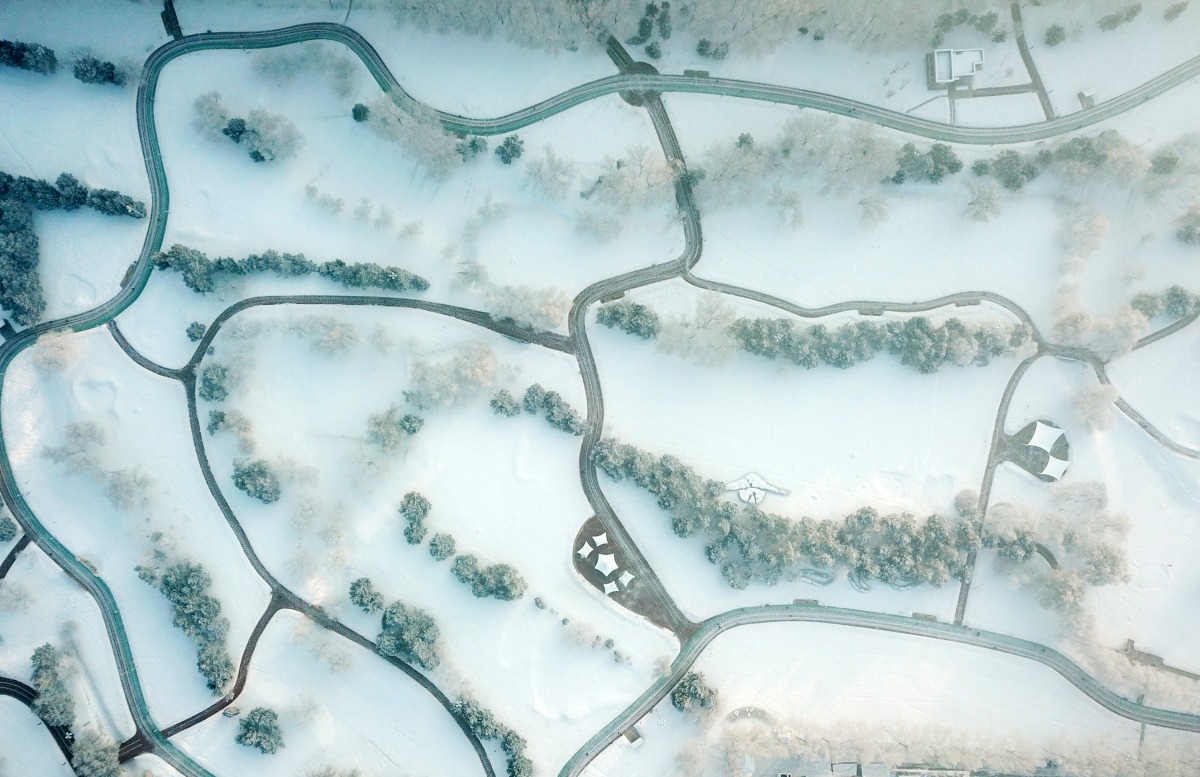 This aerial photo taken on Jan. 3, 2024 shows rime-covered trees at Xiangjiang Park in Harbin, northeast China's Heilongjiang Province. (Xinhua/Wang Jianwei)