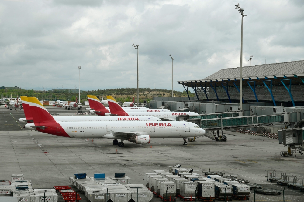 Planes by Spain's flagship carrier Iberia are parked at the Madrid-Barajas Adolfo Suarez Airport in Barajas on April 7, 2020. Photo by JAVIER SORIANO / AFP