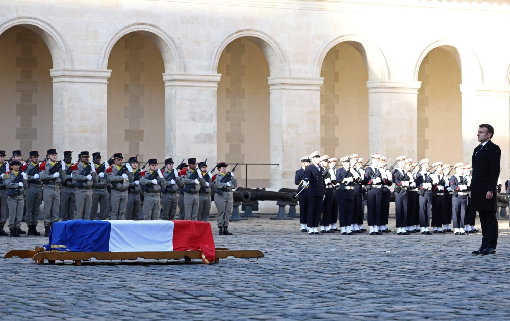 French President Emmanuel Macron (R) stands in front of the coffin of late French minister and European Union Commission president Jacques Delors during a national ceremony at the Hotel des Invalides in Paris, on January 5, 2024. Photo by STEPHANIE LECOCQ / POOL / AFP