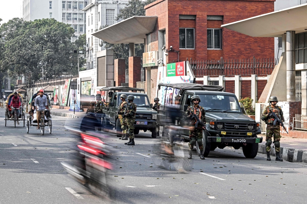 Army soldiers patrol outside the state secretariat in Dhaka on January 6, 2024 on the eve of Bangladesh's general elections. (Photo by Munir UZ ZAMAN / AFP)