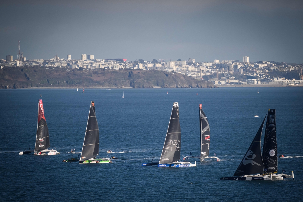 Ultim multihulls take the start of the Arkea Ultim Challenge, a solo round-the-world race on a multihull, off the coast of Brest, on January 7, 2024. (Photo by Loic Venance / AFP)