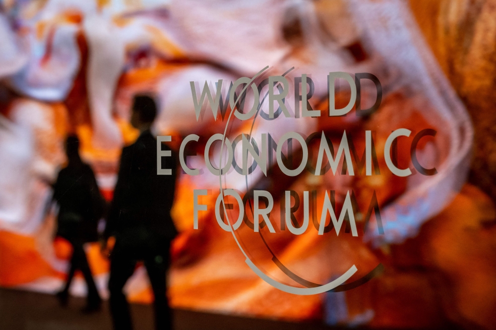 (Files) A photograph shows a sign of the World Economic Forum (WEF) at the Congress centre on the opening day of the World Economic Forum (WEF) annual meeting in Davos on January 16, 2023. (Photo by Fabrice Coffrini / AFP)