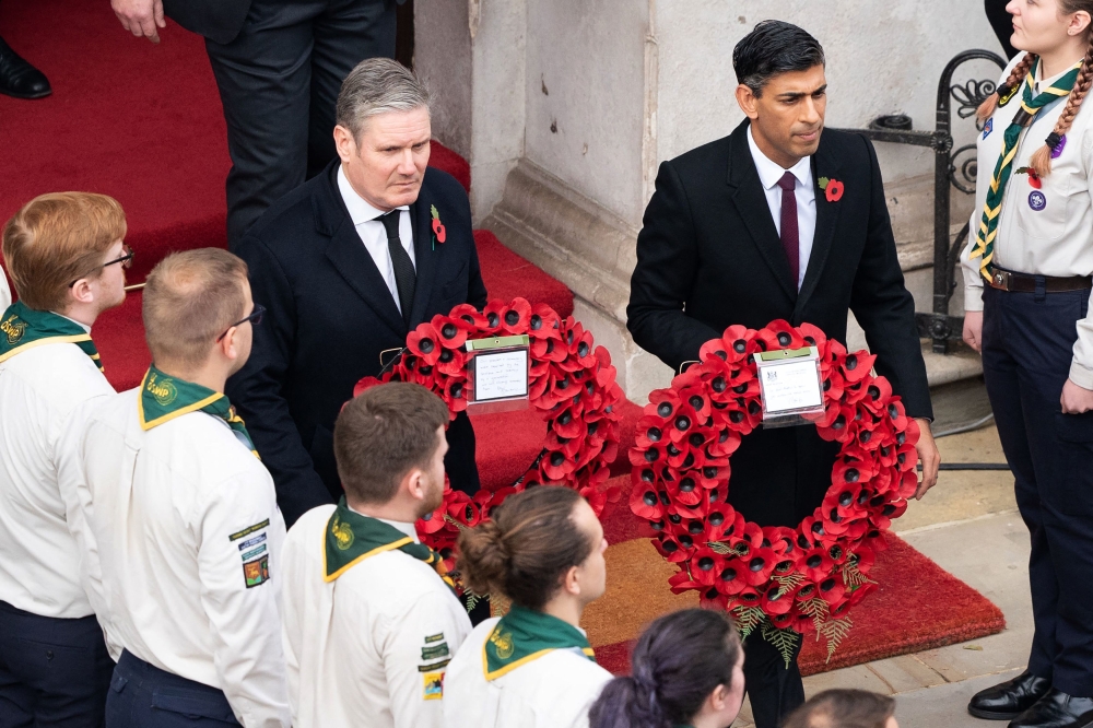 Britain's main opposition Labour Party leader Keir Starmer (left) and Britain's Prime Minister Rishi Sunak come out to lay wreaths at The Cenotaph during the Remembrance Sunday ceremony on Whitehall in central London, on November 13, 2022. (Photo by Stefan Rousseau / POOL / AFP)
