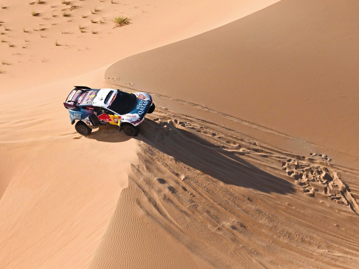 Nasser Racing’s Qatari driver Nasser Al Attiyah drives his car with French co-driver Mathieu Baumel through the dunes as they compete in Stage 5 of the Dakar Rally 2024. 