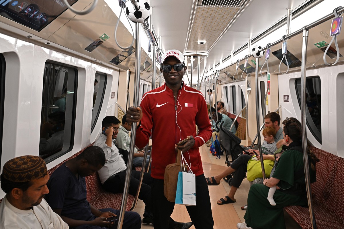 Commuters travel in a metro in Doha on January 11, 2024, on the eve of the AFC Qatar 2023 Asian Cup Group A football inaugural match between Qatar and Lebanon. (Photo by HECTOR RETAMAL / AFP)
