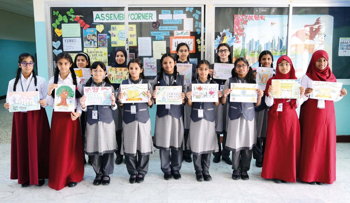 Students display posters they created using Hindi quotes. 