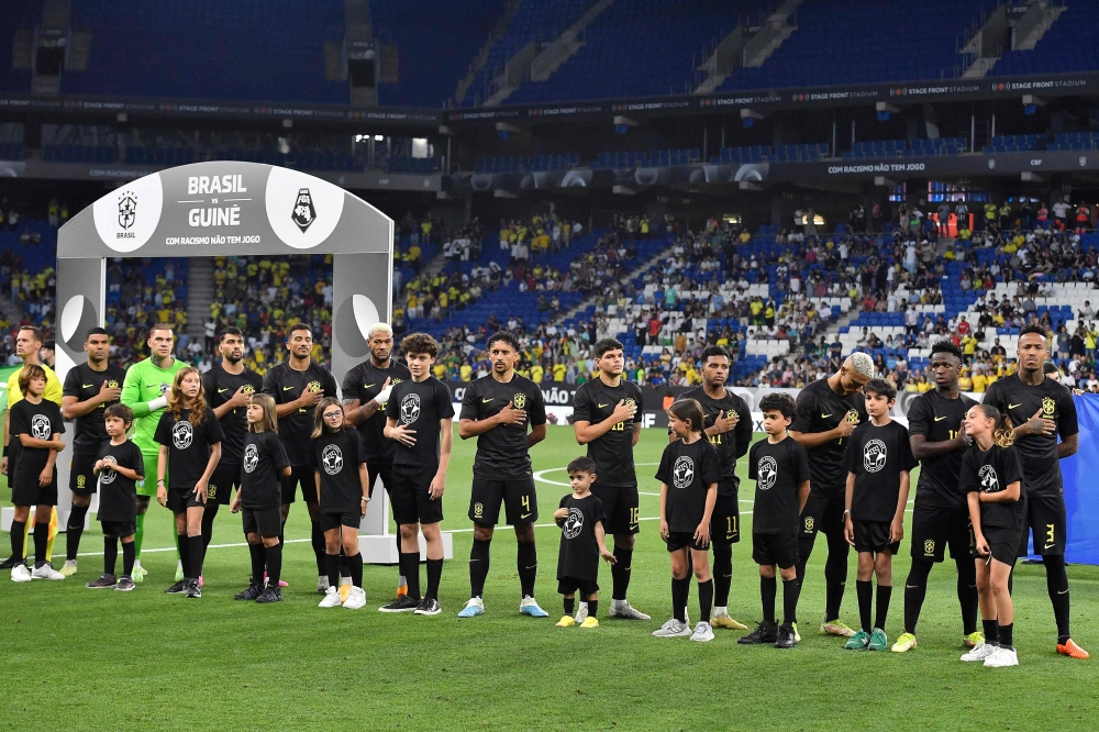 Brazil's players line up for national anthems before the start of the international friendly football match between Brazil and Guinea at the RCDE Stadium in Cornella de Llobregat near Barcelona on June 17, 2023. (Photo by Pau BARRENA / AFP)

