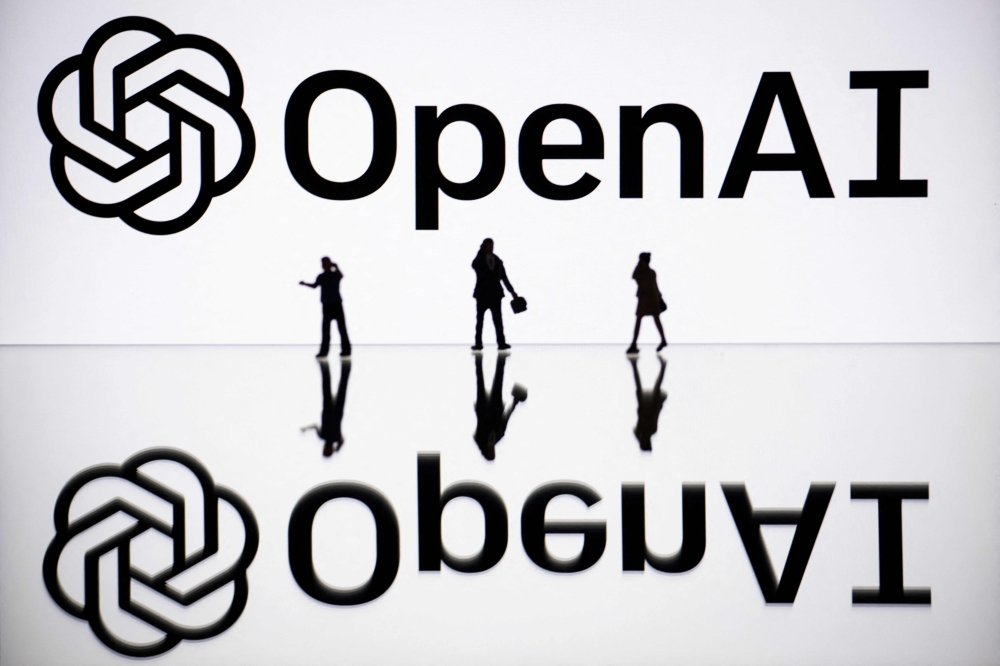 (Files) This illustration photograph taken on October 30, 2023, in Mulhouse, eastern France, shows figurines next to a screen displaying a logo of OpenAI. (Photo by Sebastien Bozon / AFP)
 