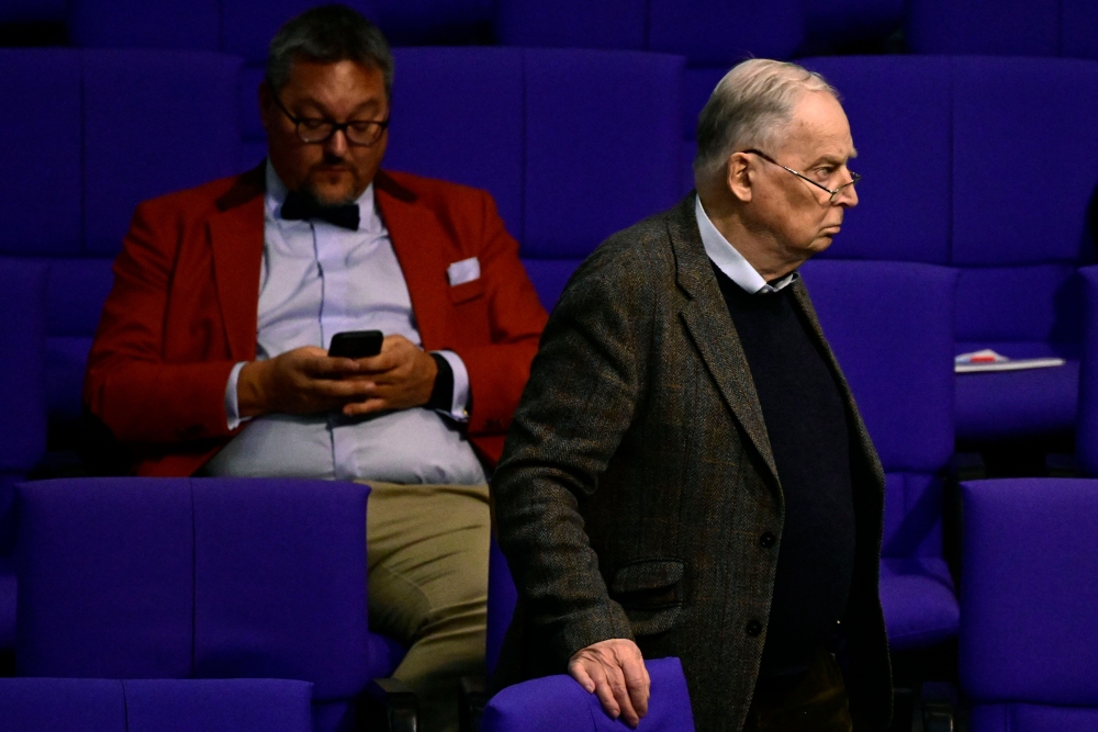 Honorary chairman of Germany's far-right Alternative for Germany (AfD) party Alexander Gauland (R) walks past AfD parliamentary group member Stefan Keuter as they attend a debate at the Bundestag (lower house of parliament) over a meeting of AfD officials with an Austrian extremist leader in November 2023, where mass deportations of immigrants were discussed, on January 18, 2024 at the Bundestag in Berlin. (Photo by JOHN MACDOUGALL / AFP)
