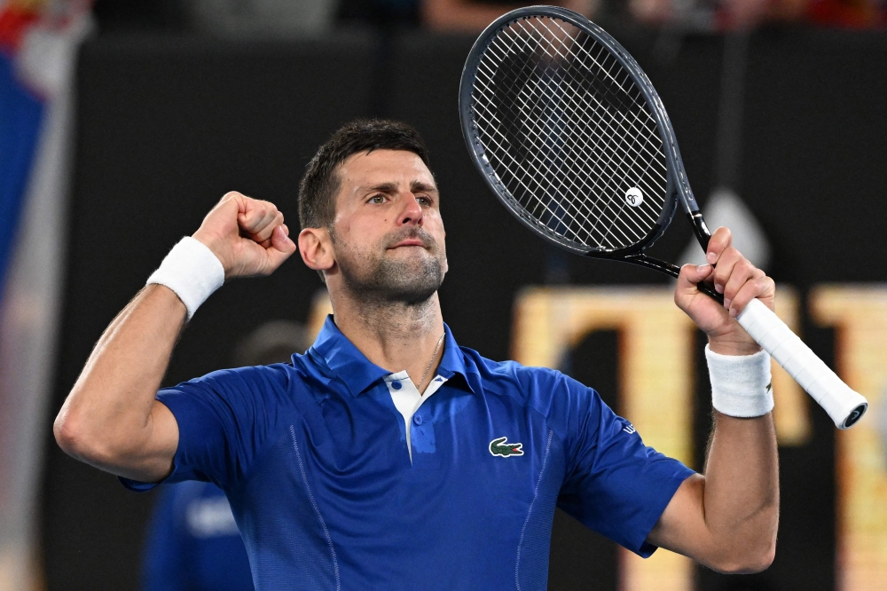 Serbia's Novak Djokovic celebrates after victory against Argentina's Tomas Etcheverry during their men's singles match on day six of the Australian Open tennis tournament in Melbourne on January 19, 2024. (Photo by WILLIAM WEST / AFP) 