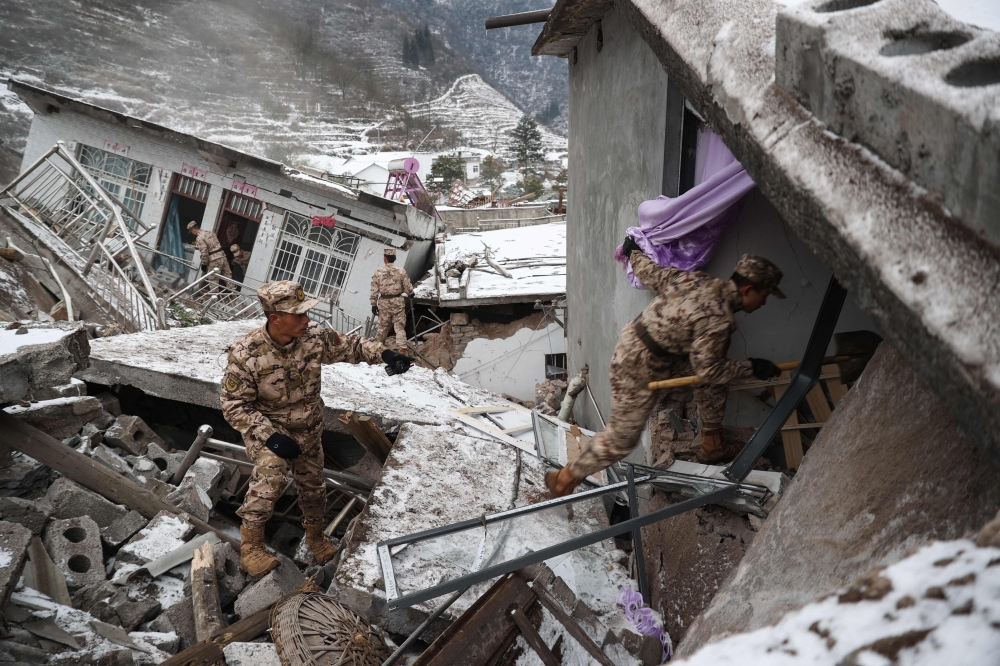 This picture taken on January 22, 2024 shows Chinese military police and rescue workers searching for missing victims at a landslide site in Liangshui village in Zhaotong, in southwestern China's Yunnan province. Photo by AFP
