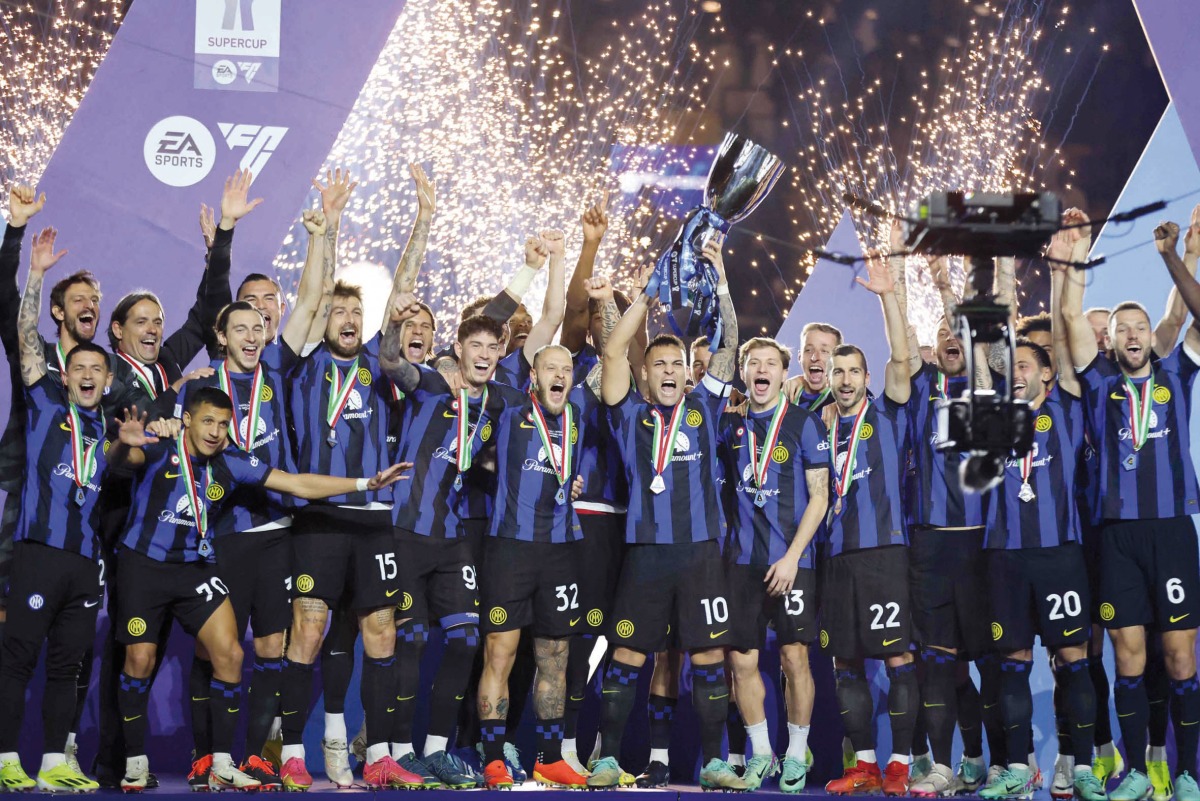 Inter Milan’s players celebrate with the trophy. AFP 