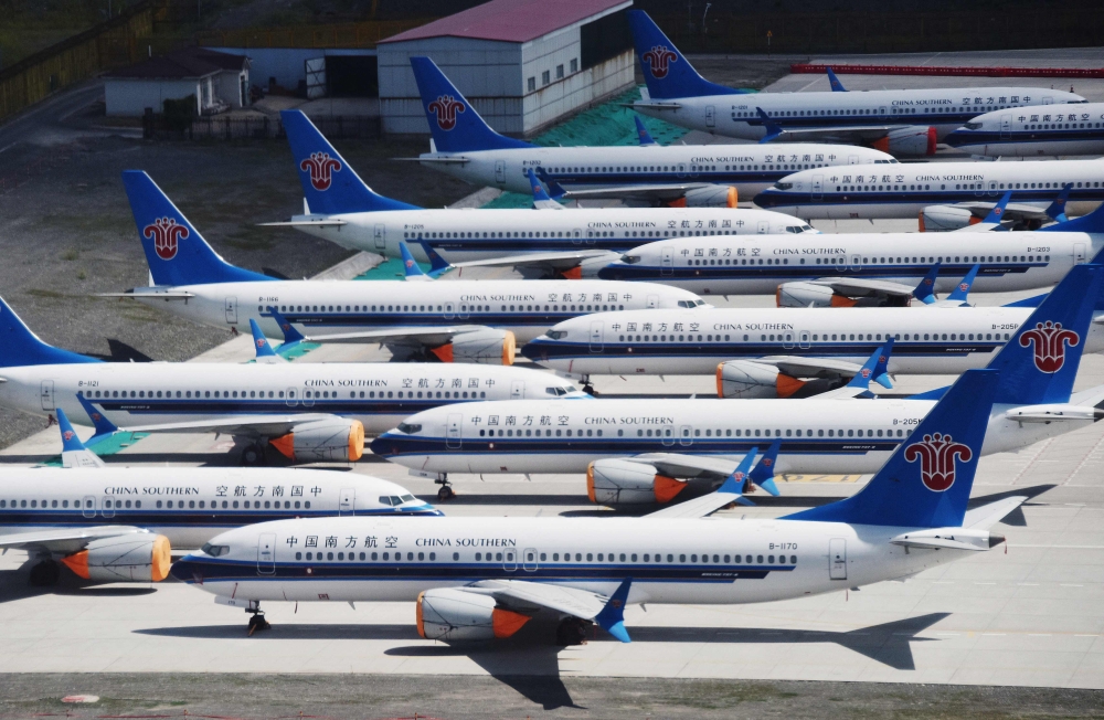 This photo taken on June 5, 2019 shows grounded China Southern Airlines Boeing 737 MAX aircraft parked in a line at Urumqi airport, in China's western Xinjiiang region. Photo by GREG BAKER / AFP