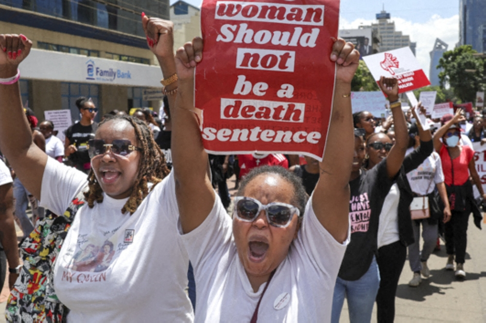 Activists shout as they demonstrate in the Central Business District against an alarming rise in murders of young women in Nairobi on January 27, 2024. (Photo by Tony KARUMBA / AFP)
