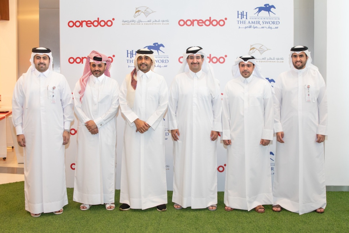 Officials of Ooredoo Qatar and Qatar Racing and Equestrian Club pose for a photograph following the sponsorship signing ceremony.