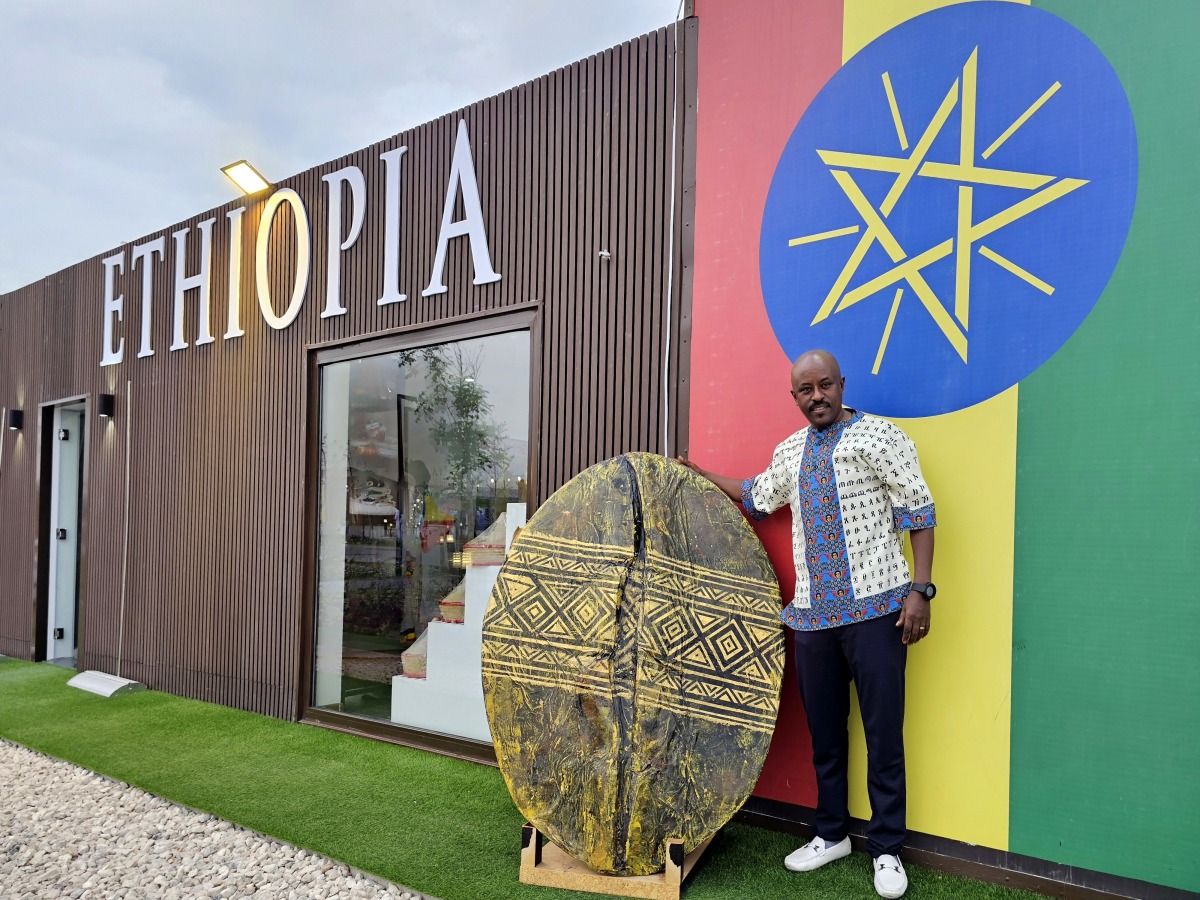 Tessema Asrate poses with his 3D coffee bean sculpture in front of the Ethiopian pavilion at Expo Doha. (Pics: Marivie Alabanza / The Peninsula)