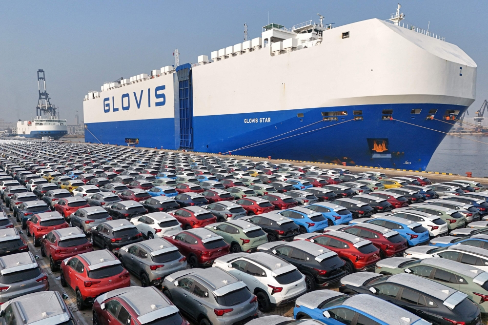 (Files) This file photo taken on January 2, 2024, shows cars waiting to be loaded onto a ship for export at the port in Yantai, in China's eastern Shandong province. (Photo by AFP) 