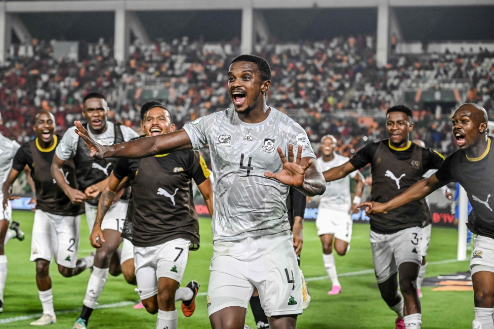 South Africa's midfielder #4 Teboho Mokoena (C) celebrates with teammates after scoring a goal during the Africa Cup of Nations (CAN) 2024 round of 16 football match between Morocco and South Africa at the Stade Laurent Pokou in San Pedro on January 30, 2024. (Photo by SIA KAMBOU / AFP)
