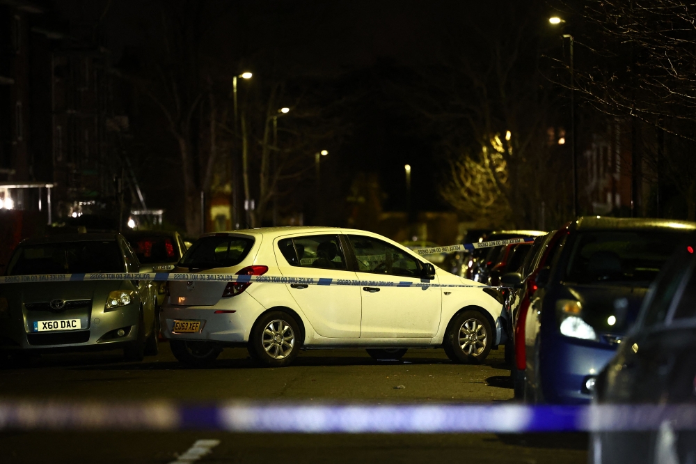 A car is seen behind police cordon after a suspected acid attack in south London on February 1, 2024. Photo by HENRY NICHOLLS / AFP