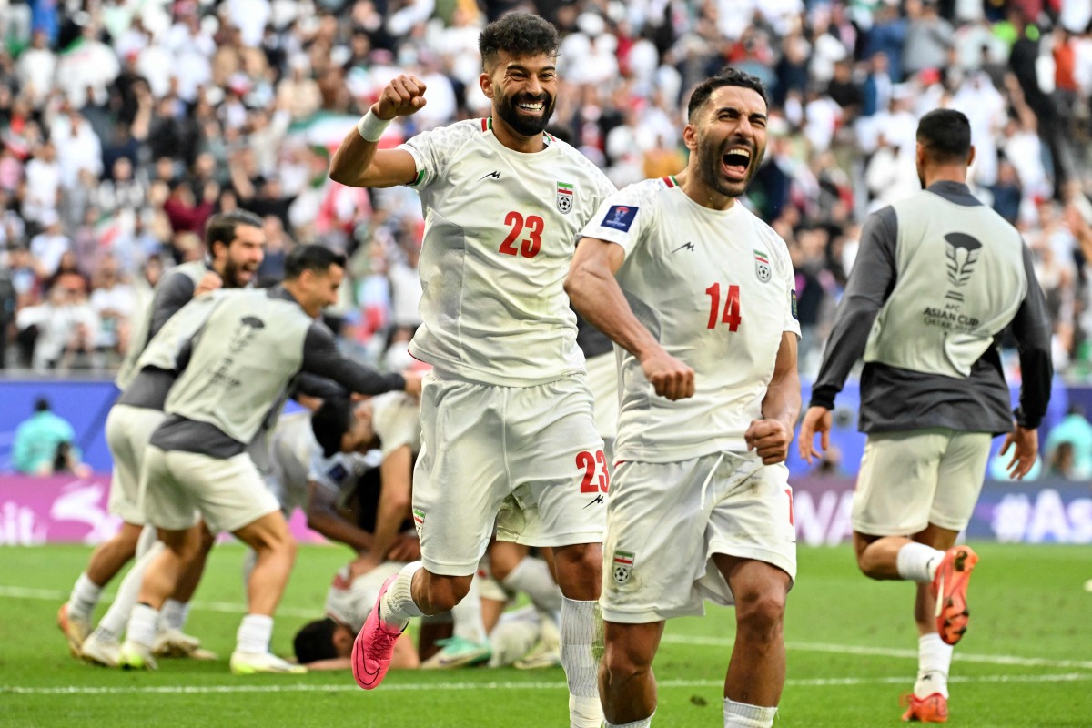 Iran's players celebrate their team's second goal during the Qatar 2023 AFC Asian Cup quarter-final football match between Iran and Japan at Education City Stadium in al-Rayyan, west of Doha, on February 3, 2024. (Photo by HECTOR RETAMAL / AFP)