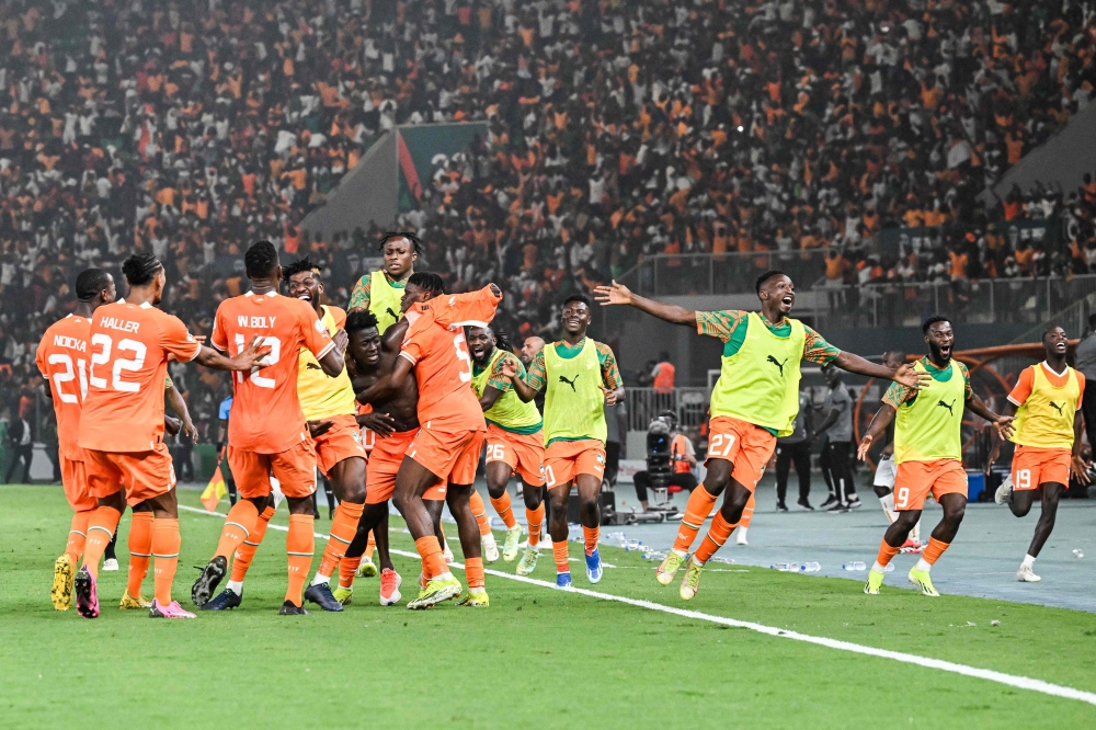 Ivory Coast's forward #14 Oumar Diakite (C) takes his jersey off as he celebrates with teammates after scoring his team's second goal during the Africa Cup of Nations (CAN) 2024 quarter-final football match between Mali and Ivory Coast at the Stade de la Paix in Bouake on February 3, 2024. (Photo by Issouf SANOGO / AFP)
