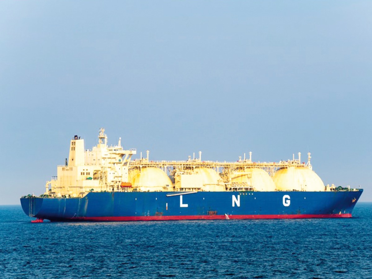 Blue coloured hull large liquefied natural gas (LNG) carrier with 4 LNG tanks sails along the sea.