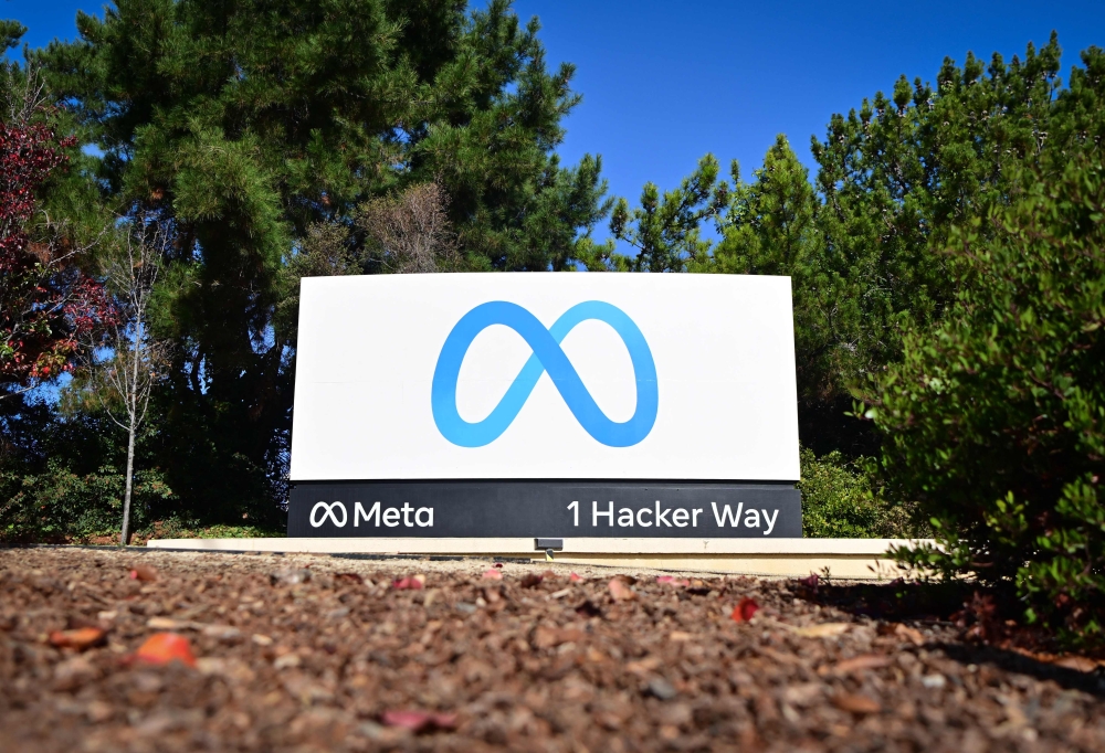 File: The Meta (formerly Facebook) logo marks the entrance of their corporate headquarters in Menlo Park, California on November 9, 2022. (Photo by Josh Edelson / AFP)
